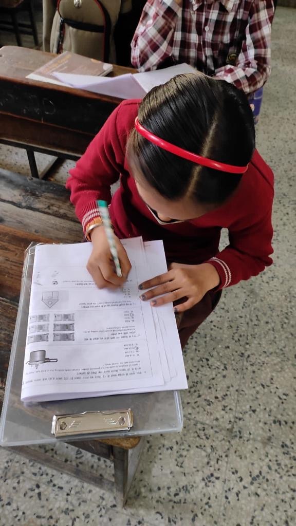 Student completing a written assessment